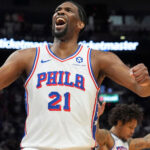 Joel Embiid, in jersey No.21, celebrates a moment during a game. The 76ers lock up Embiid to three years and USD192.9 million extension.