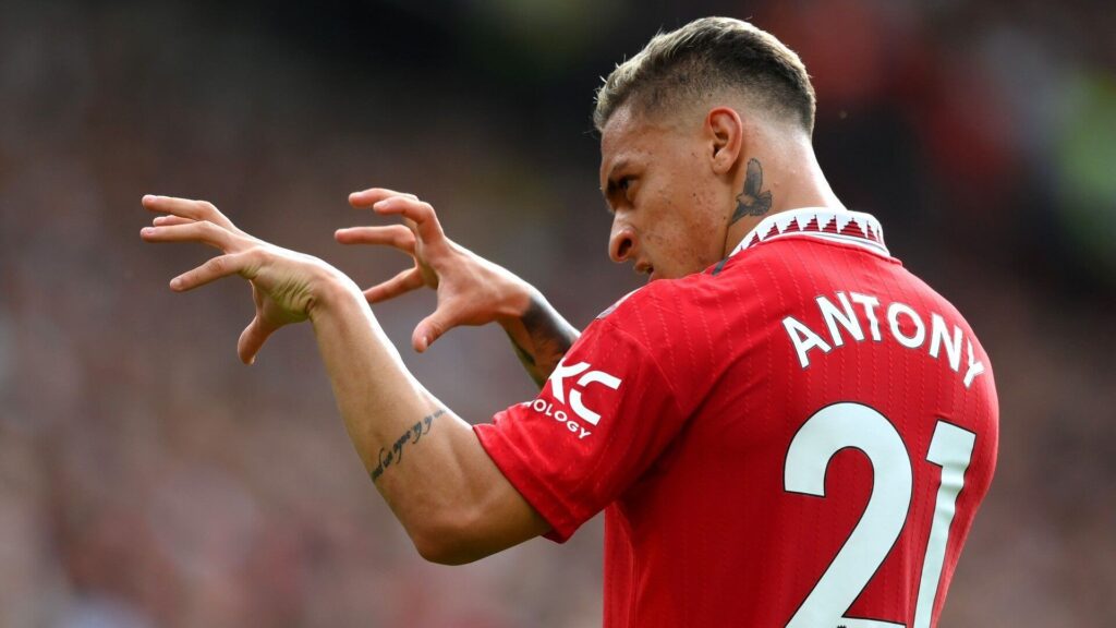 Antony, in red and white uniform, gestures during a break from a match. Antony wanrs to stay with Manchester United amid interest from Fenerbahce