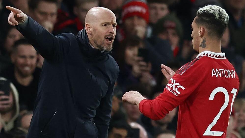 United manager Erik Ten Hah, left, in black jackets, gives instructions to Antony, in red jersey No.21, during a match. Ten Hag wants Antony to fight for his playing time