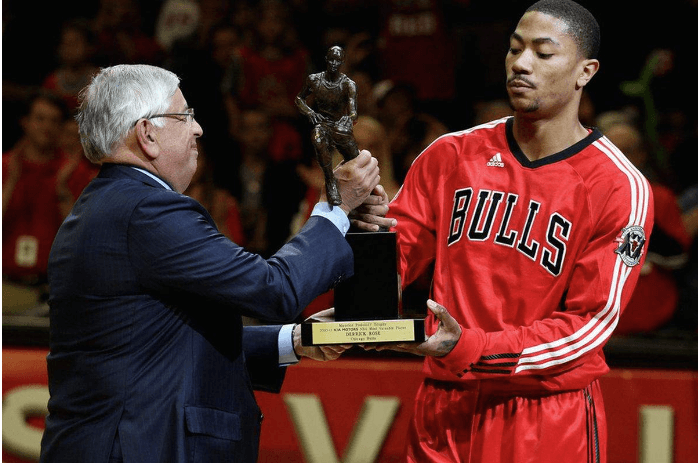 Derrick Rose, in red Bulls shirt, receives trophy from then NBA commissioner David Stern. Rose became the youngest MVP winner at 22 years old.