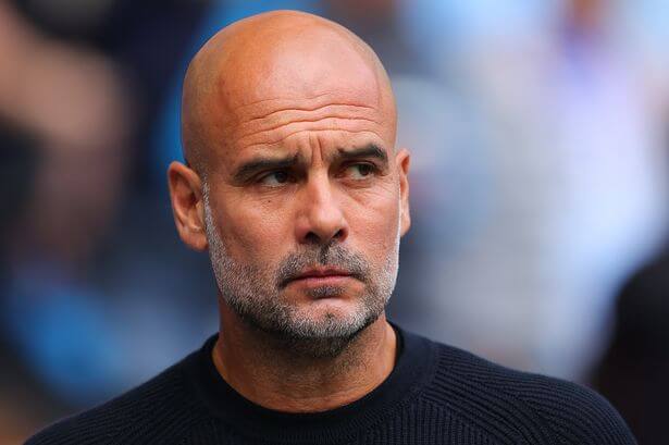 Man City manager Pep Guardiola, in black shirt, looks focused during a match. Guardiola says he's looking forward to City's independent hearing