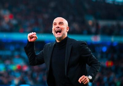 City manager Pep Guadiola, in black jacket, pumps his fist in celebration during a match. Guardiola praised City as a "fantastic team" after a draw against Inter.