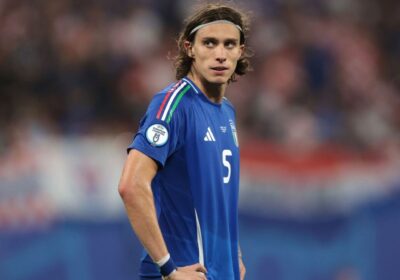 Ricardo Calafiori, in blue uniform, looks on during a break at a match. Italy has released Calafiori back to Arsenal.