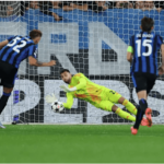 Arsenal goalkeeper David Raya, center, in yellow uniform, catches the ball from reaching the net during the Arsenal-Atalanta match. Managers praised Raya's double save after the match