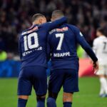 Neymar, left in jersey N0. 10, and Kylian Mbappe, right with jersey No. 7, share a light moment during a match. Neymar warns Real Madrid's Brazilian players on playing with Mbappe