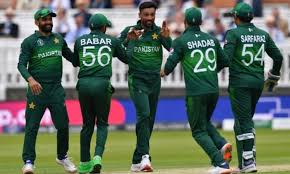 The PCB men's national cricket team, in green uniforms, tries to map out a strategy in the field during a match.