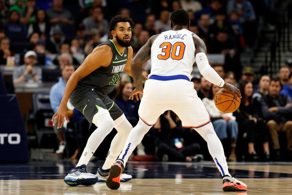 Julius Randle, right, with Knicks jersey No. 30, and Karl Anthony Twons, in black jersey, face off in an NBA game. Towns was traded from Minnesota to New York for Randle, Donte Divincenzo and a draft pick