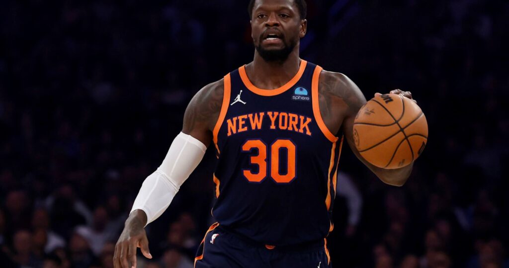 Julius Randle, in Knicks jerse No. 30, dribbles the ball in a game. Randle was traded by New York to Minnesota as part of the Karl Anthony Towns deal