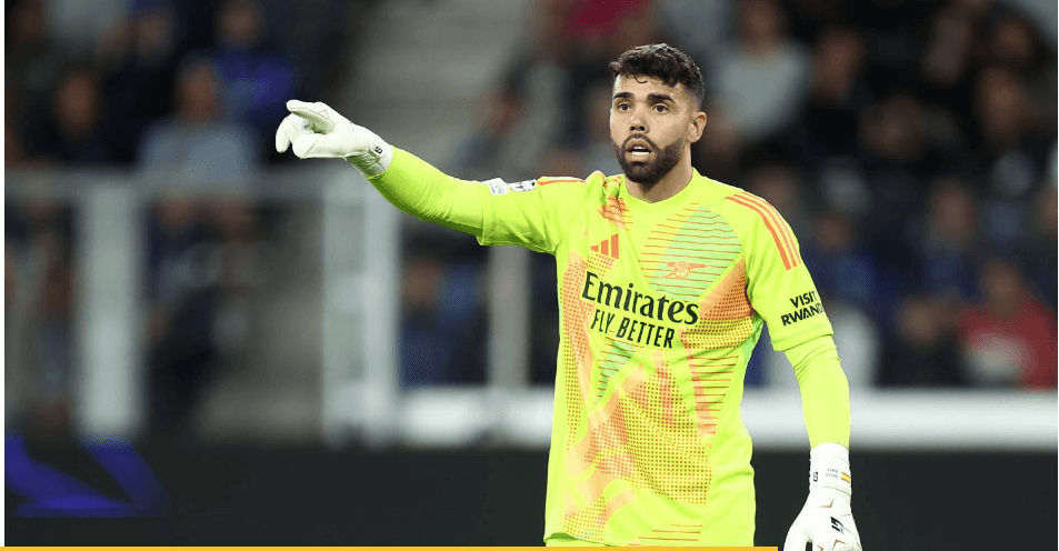 Arsenal goalkeeper David Raya points his finger to the crowd during a match break. Managers from both teams praised Raya's double save after the Arsenal-Atalanta match