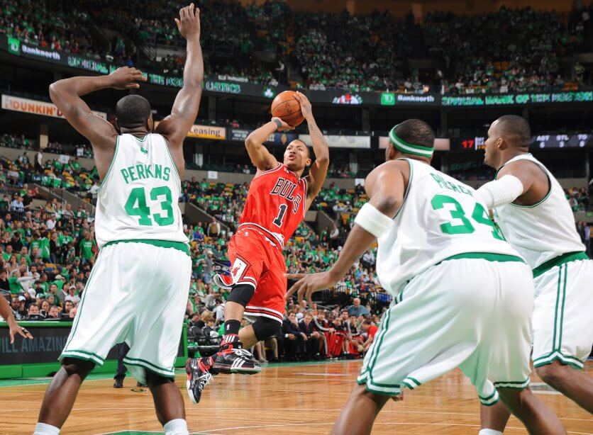 Derrick Rose, in Bulls red jersey No1, shoots over three Boston defenders. Rose made his NBA playoff debut with 36 points in leading Chicago over Boston