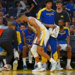 Golden State guard Stephen Curry, in white jersey, limps toward the bench as the Dubs faced the Los Angeles Clippers on Sunday. Curry twists ankle as Warriors lose