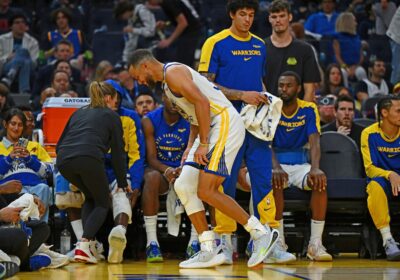 Golden State guard Stephen Curry, in white jersey, limps toward the bench as the Dubs faced the Los Angeles Clippers on Sunday. Curry twists ankle as Warriors lose