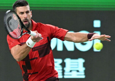 Novak Djokovic returns a shot against Flavio Cobolli at the Shanghai Open. Djokovic advanced to the fourth round.