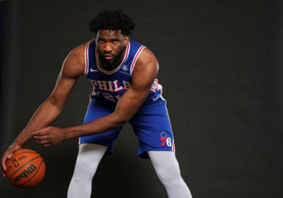 Joel Embiid, in blue jersey, poses for a team media day activity in file photo. NBA to review Embiid's absence in 76ers-Bucks game, preseason