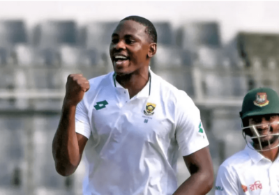 South Africa's Kagiso Rabada, in white shirt and without helmet, pumps his fist as a teammate looks on. Ragada regains ICC Test rankings top spot as premier bowler