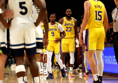 LeBron James (No.23) and Bronny James (No.9) enter the court in the second quarter of their game against the Minnesota Timberwolves. LeBron, Bronny play together in historic Lakers' NBA opener