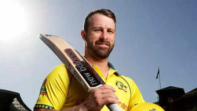 Matthew Wade, in yellow uniform, poses, in a file photo. Matthew Wade eyes coaching after international cricket retirement