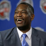 Dikember Mutombo, in gray suit, had a happy moment at a news conference. The NBA community mourns as Mutombo passed away