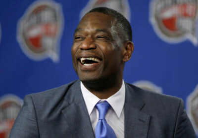 Dikember Mutombo, in gray suit, had a happy moment at a news conference. The NBA community mourns as Mutombo passed away