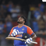 Sanju Samson, in blue and orange uniform, looks in the sky during a lull in India's Test match against Bangladesh. Samson was honored in India for topping Rohit Sharma's T20I record.