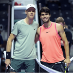 Jannik Sinner, in light green shirt, and Carlos Alcaraz, in orange shirt, pose for photographers in a file photo. Sinner tops Alcaraz for Six Kings Slam title.