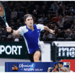 Greece's Stefanos Tsitsipas, in blue and white shirt, tries to return the ball at the 2024 Paris Masters on Monday. Tsitsipas beats Baena in Paris Masters opener