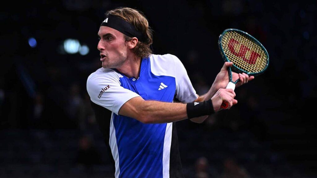 Greece's Stefanos Tsitsipas, in blue and white shirt, attempts to return a shot at the 2024 Paris Masters on Monday.Tsitsipas beats Baena in Paris Masters opener