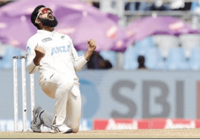 Ajaz Patel pumps both fists in celebration in New Zealand's third Test against India in Mumbai on Sunday. Patel fires 11 wickets to power New Zealand over India in third Test