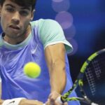 Spain's Carlos Alcaraz, in light blue/green shirt, returns a shot against Andrey Rublev in their match on Wednesday. Alcaraz bounces back, beats Rublev in ATP Finals