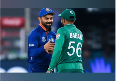 India's Virat Kohli (left, in blue), shakes hands with Pakistan's Babar Azam (right, in green), during a break in a match. Azam surges to 2nd in T20I run-scorers' list after surpassing Kohli