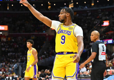 Los Angeles guard Bronny James gestures to a teammate during warmups before a game. Bronny James to G League as Lakers made it official