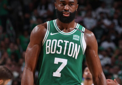 Celtics star Jaylen Brown, in Celtics green jersey No.7, walks on the floor at a recent game. Brown, Nike trade barbs over 'childish' Giannis reference