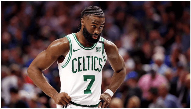 Celtics star Jaylen Brown, in white Celtics No.7 jersey, gestures during a break at a game. Brown, Nike trade barbs over 'childish' Giannis reference