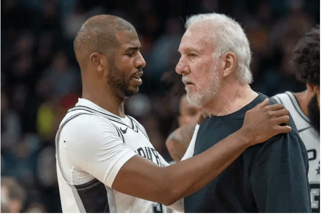 San Antonio point guard Chris Paul, left in white jersey, and coach Gregg Popovich, right in black shirt, discuss strategies at a recent game. Expect the Spurs "to play hard and compete" for Gregg Popovich, as the coach's undisclosed illness forced him to go on indefinite leave.