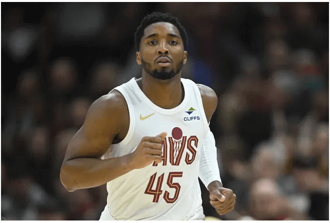 Cleveland guard Donovan Mitchell, in white Cavs jersey, runs on the court during the Cavs-Chicago Bulls match on Monday. The Cavs set a record as the seventh team with a 12-0 start on Monday after Cleveland beat the Chicago Bulls.