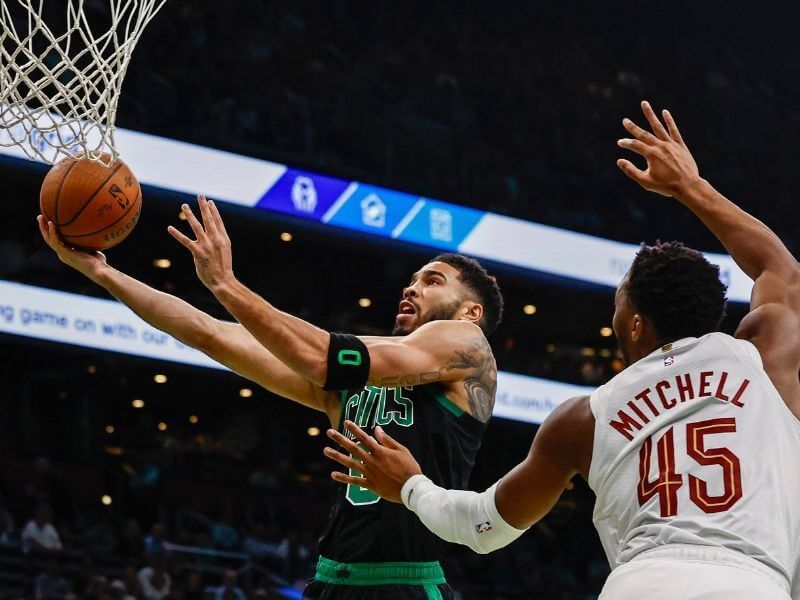 Celtics forward Jayson Tatum (left, 0), drives past Cavs guard Donovan Mitchell (right 45) in the two teams' match at the TD Garden on Tuesday. Celtics hand Cavs first loss, snap Cleveland's 15-game win streak