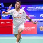 Indonesia's Jonatan Christie, in white uniform, returns a shot in Shenzhen. China Masters 2024: Christie tops Loh