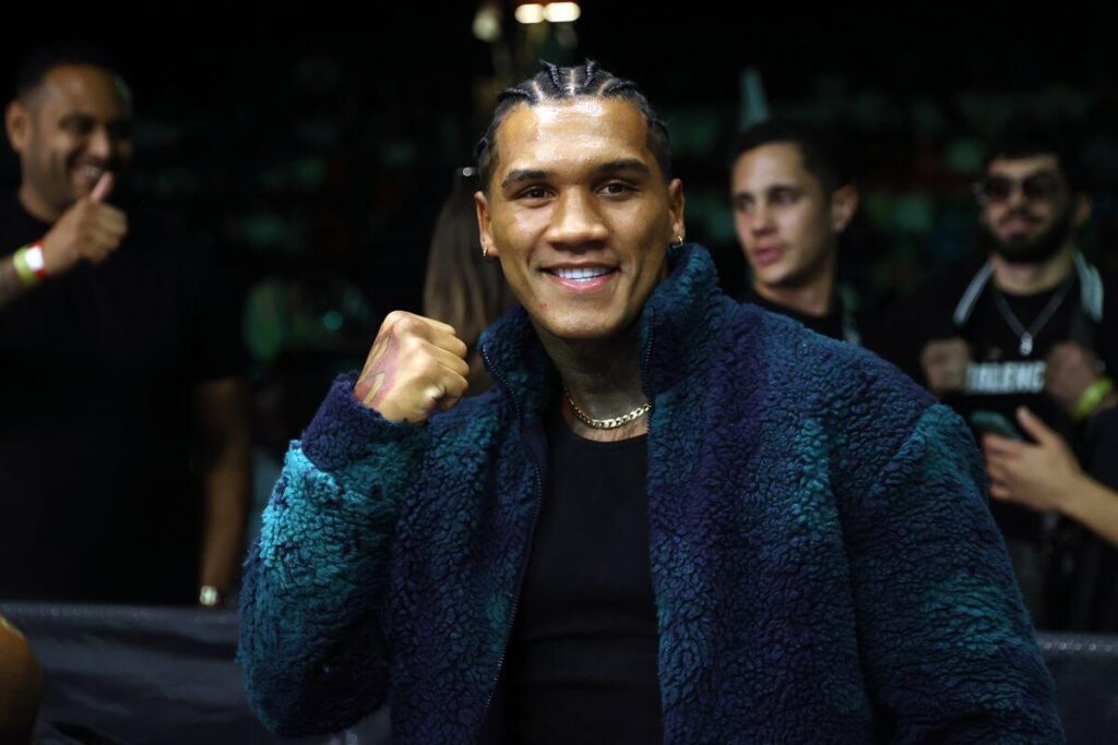 English fighter Conor Benn, in black coat, makes a fighting pose before the cameras at a recent news conference. Benn suspension lifted