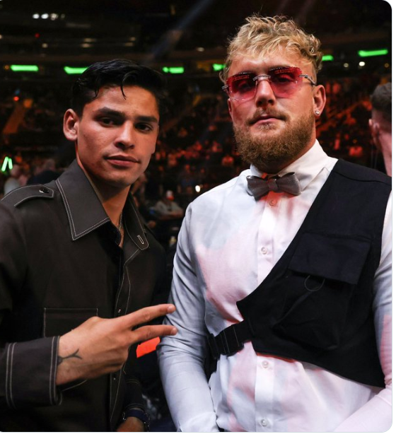 Ryan Garcia (left, in black polo) and Jake Paul (right, in white polo) pose for photographers in file photo. Garcia open to Paul fight after suspension, predicts KO in 5 rounds