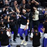 Klay Thompson, center, with hands raised, acknowledges the cheers of the crowd on Tuesday. Thompson gets 'Captain Klay' tribute in Chase Center return