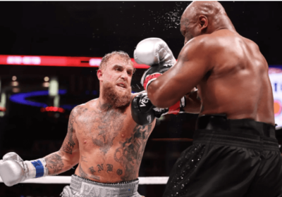 American Jake Paul, left, in gray shorts, lunges at Mike Tyson, right in black shorts, in their fight on Saturday. Paul gets title fight, rematch offers from Dubois, Beterbiev, Fury