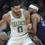 Boston forward Jayson Tatum (left, in white jersey) posts up against the Minnesota Timberwolves at TD Garden on Sunday. Tatum gets 'fun' at Edwards' trash-talk antics as Celtics top Wolves