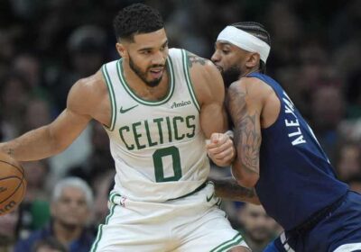 Boston forward Jayson Tatum (left, in white jersey) posts up against the Minnesota Timberwolves at TD Garden on Sunday. Tatum gets 'fun' at Edwards' trash-talk antics as Celtics top Wolves