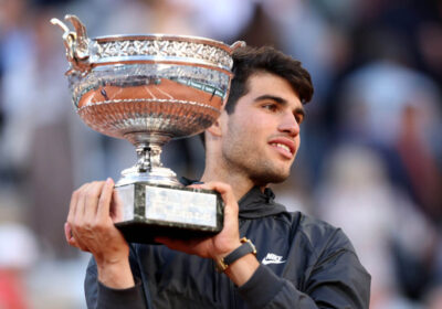 Spain's Carlos Alcaraz (in black jacket) clutches one of his trophies he won in 2024. Alcaraz has to learn 'how to say no' to manage schedule, says Roddick