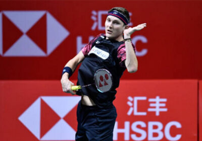 Denmark's Viktor Axelsen (in black and purple shirt) returns a shot in file photo. Axelsen pulls out of World Tour Finals 2024 due to foot injury