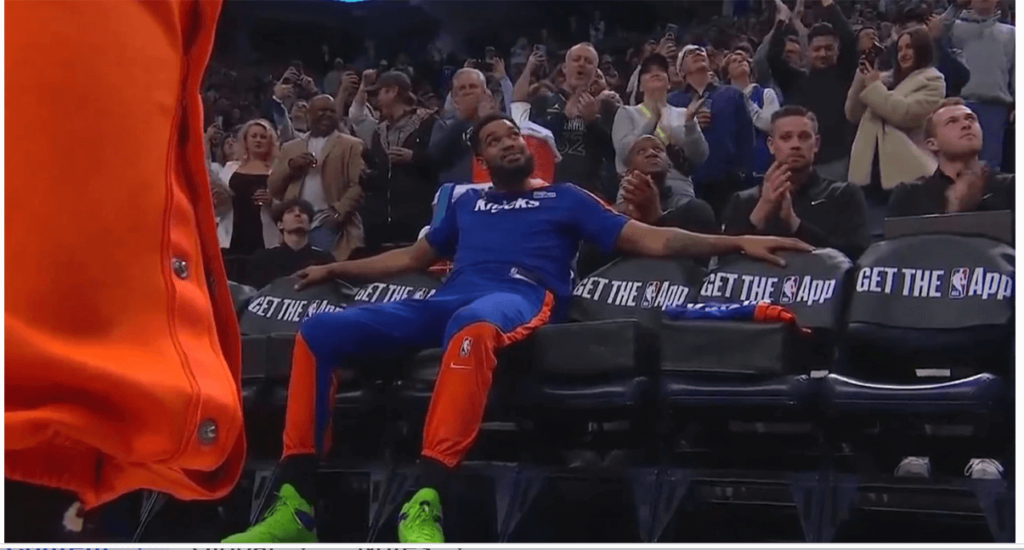 New York Knicks center Karl Anthony Towns, in blue shirt, looks on the scorebpard as he cheers the crowd's approval at the Target Center on Thursday. Towns gets warm welcome, standing ovation in Minnesota return