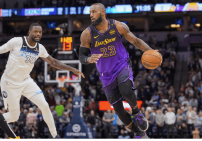 Los Angeles forward LeBron James (23) tries to drive against Wolves big man Julius Randle (30) in the Lakers-Wolves match on Monday. James held down to season-low 10 points as Lakers lose to Wolves