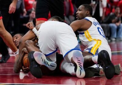 A loose ball scramble ensues between Houston's Jalen Green (partly hidden, left), and Golden State's Jonathan Kuminga (right, 0) even as an unidentified Warriors player (middle) joins the fray in Wednesday's game. NBA rules refs made right Kuminga foul call in Dubs' loss