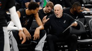 San Antonio coach Gregg Popovich (right) hollers instructions to star center Victor Wembanyama (left) on the bench in file photo. Popovich recovering but 'no timeline' set for Spurs' return: report