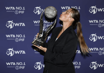 Belarus' Aryna Sabakebka, center, attempts to kiss her tropy she received from the Women's Tennis Association (WTA) on Monday. Sabalenka wins WTA Player of the Year award